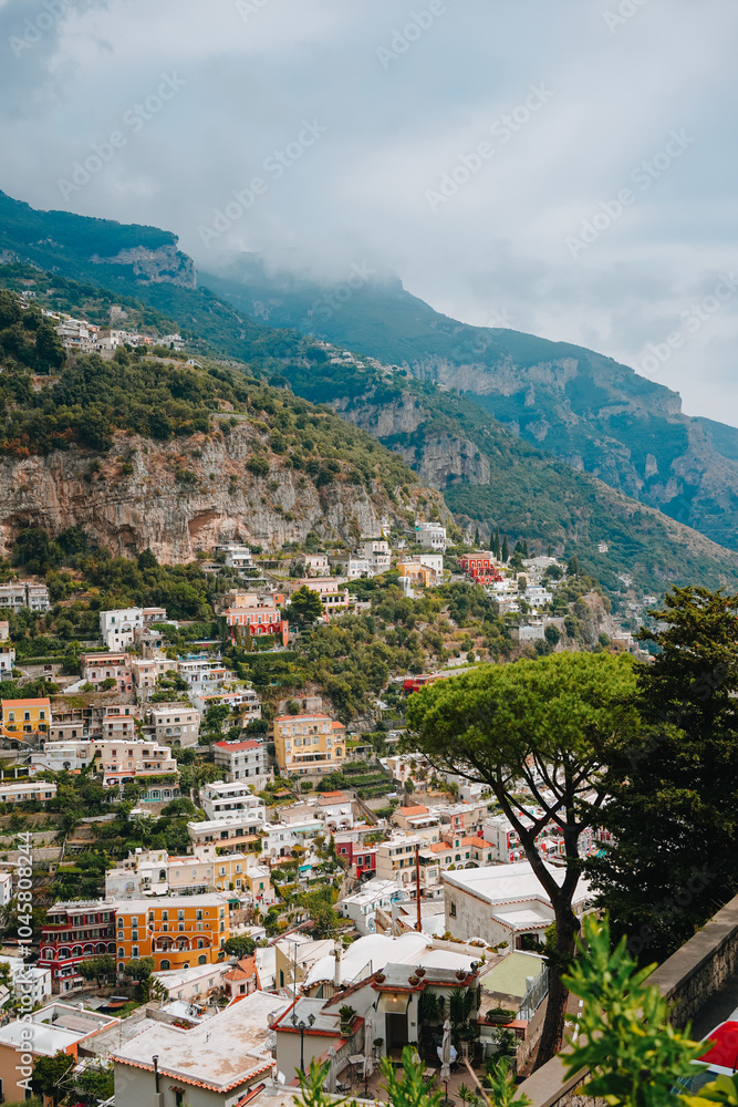 Obraz premium Amalfi coast, Italy. A beautiful Amalfi coast, Positano town with colorful houses on the cliff, green hills, and the Tyrrhenian Sea. Sunny summer day in Positano