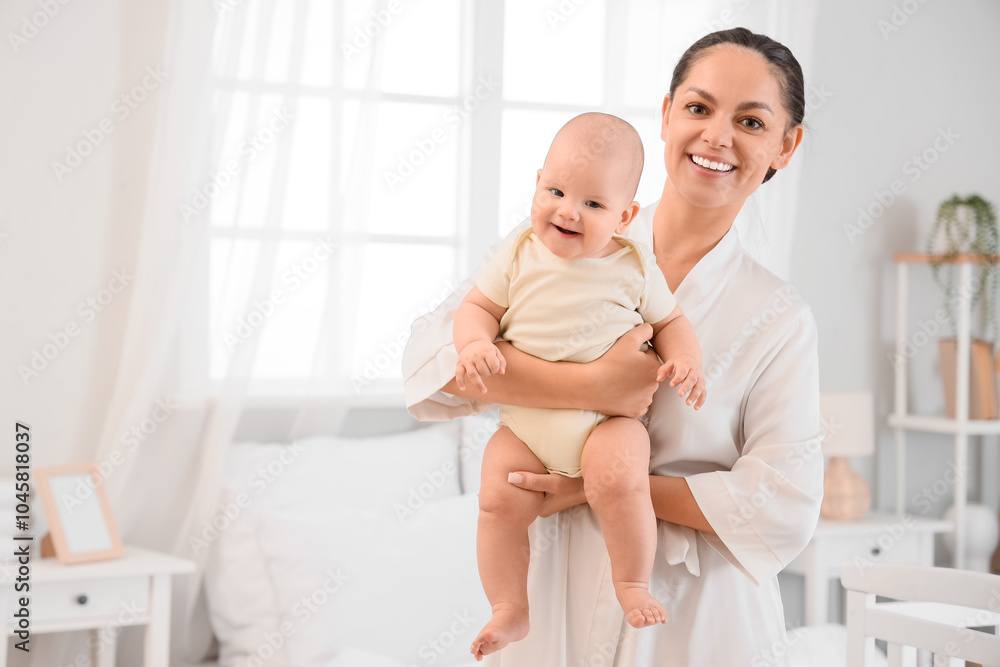 Happy mother holding her little baby in bedroom Happy mother holding her little baby in bedroom