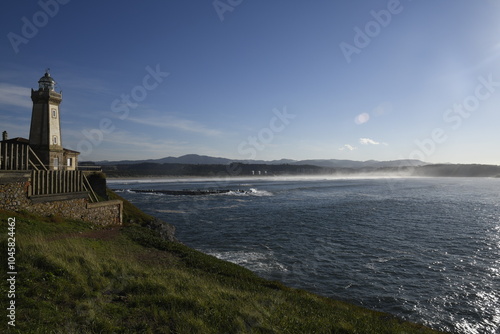 Faro de Avilés en día de sol con gran oleaje photo