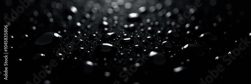 A mesmerizing close-up of droplets on a dark surface, creating a serene ambiance perfect for backgrounds, design, and artistic projects.