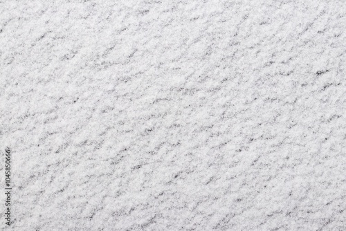 Photos the texture of the first snow, through which the ground is slightly visible