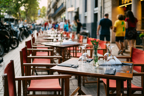 Outdoor Cafe in Barcelona with Empty Tables and Street Scene