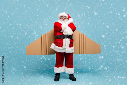 Full length body size view of his he nice fat cool content cheerful St Nicholas Santa wearing plane wings fast shipping shop delivery service folded arms isolated over blue pastel color background