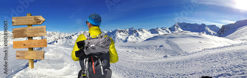 view  on  back of a hiker looking a wooden panel directionnal wooden and pano...
