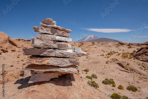 Balance rock tower for Peace and Zen with blurred scenic view of active Ollague Volcano (Ullawi) in Bolivia. Concept of balance and harmony.