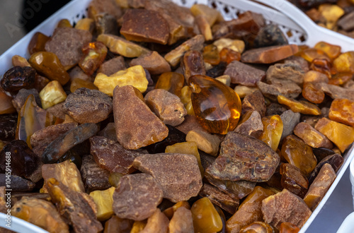 Amber stones market, polished orange gemstones closeup, natural Baltic amber gems jewelry store photo