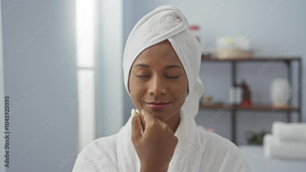 Woman enjoying relaxation at a spa with a serene expression, wearing a towel and bathrobe in a wellness center, focusing on skincare in a calming interior room atmosphere. Woman enjoying relaxation at a spa with a serene expression, wearing a towel and bathrobe in a wellness center, focusing on skincare in a calming interior room atmosphere.
