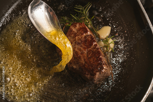A juicy beef steak sizzling in a hot pan, with mouthwatering sear marks and a rich brown crust. The steak is surrounded by herbs and garlic, enhancing the flavor and presentation.