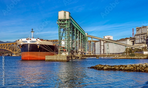 Картината върху платно Ship under loading in sea port of Vancouver  on the background of blue cloudy sk