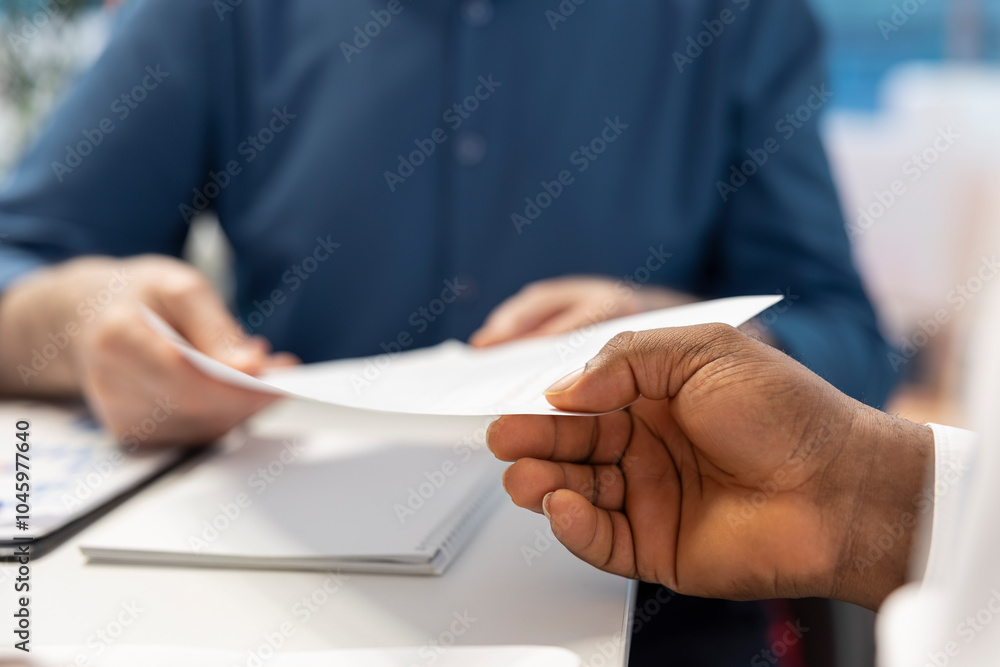 Obraz premium Senior man receiving the financial contract with retirement plan option, agreement to secure their pension and life savings for the future. Expert giving the document to his clients. Close up.