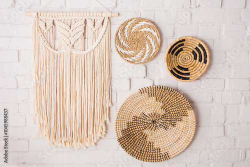 Closeup of three decorative straw plates and a macrame