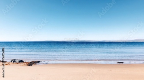   A vast expanse of water resting atop a sandy coast adjacent to an extensive sandy shore covered in copious amounts of sand
