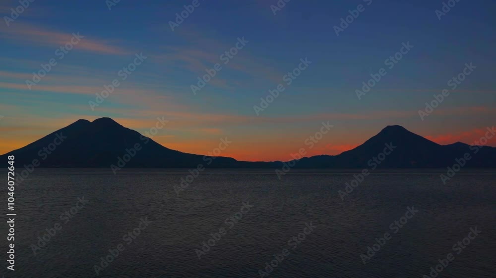 This time-lapse captures the beautiful process of sunrise at Lake Atitlan, where the first light of day slowly illuminates the water and the volcanoes surrounding the lake. This time-lapse captures the beautiful process of sunrise at Lake Atitlan, where the first light of day slowly illuminates the water and the volcanoes surrounding the lake.