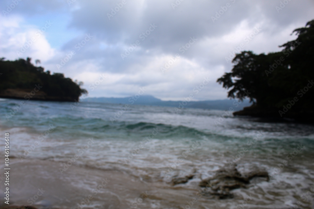 Blur view of white sand beach in summer with sea water and waves washing the shore. Blur view of white sand beach in summer with sea water and waves washing the shore.