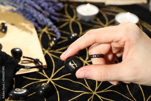 Woman with rune Hagalaz at table, closeup photo