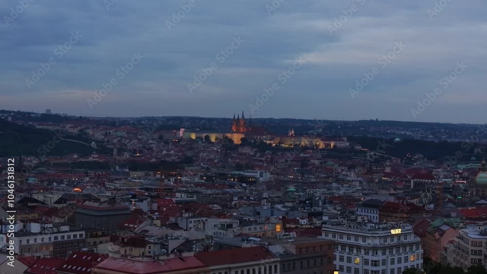 Aerial views reveal the Prague skyline at dusk, showcasing the glowing Prague Castle in the distance. City's enchanting beauty as night descends