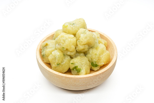 Homemade siomay with soft and chewy texture served in wooden bowl isolated on white background.