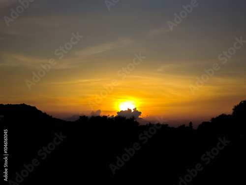 The orange evening sunlight follows the shadows of the mountain ridges.