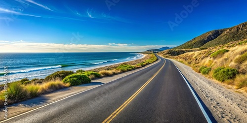 A solitary highway winds along the coast, following the curve of a sandy beach and offering breathtaking views of the azure ocean and rolling hills.