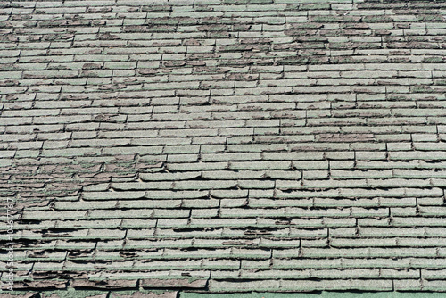 Sun Damaged Composite Shingle Roof in bad need of replacement