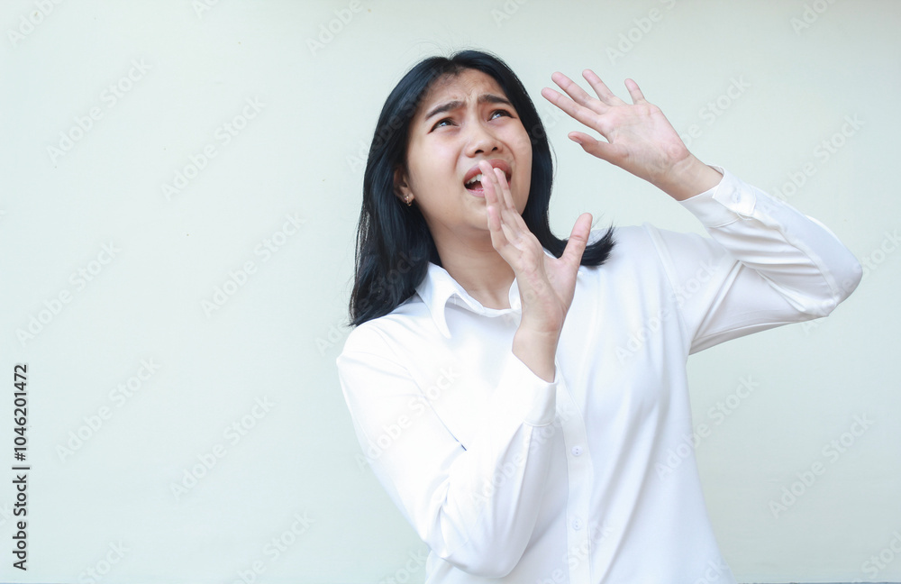 portrait of terrified asian business woman raising palms and looking up with scared face expression wearing white shirt formal suit standing over isolated background portrait of terrified asian business woman raising palms and looking up with scared face expression wearing white shirt formal suit standing over isolated background