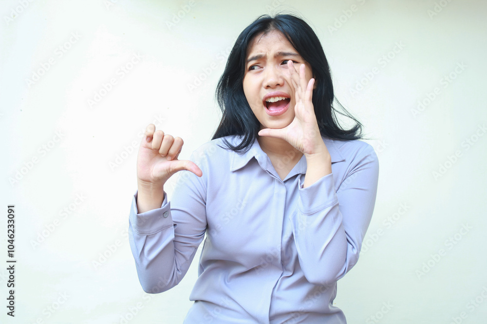 dissatisfied asian young business woman screaming with open mouth protest giving thumbs down looking away feeling upset unhappy wearing formal purple shirt standing over isolated white background dissatisfied asian young business woman screaming with open mouth protest giving thumbs down looking away feeling upset unhappy wearing formal purple shirt standing over isolated white background