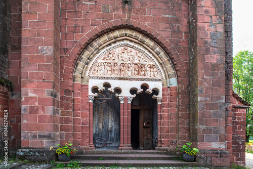 church and sculpture in red brick typical of the town of Collonges la Rouge in the Limousin region of France photo