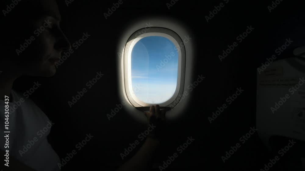 Airplane Window Shade Opening to Reveal Stunning View of Sky and Wing, Scenic Flight Experience from Inside the Plane, Aerial Travel Over the Clouds Airplane Window Shade Opening to Reveal Stunning View of Sky and Wing, Scenic Flight Experience from Inside the Plane, Aerial Travel Over the Clouds