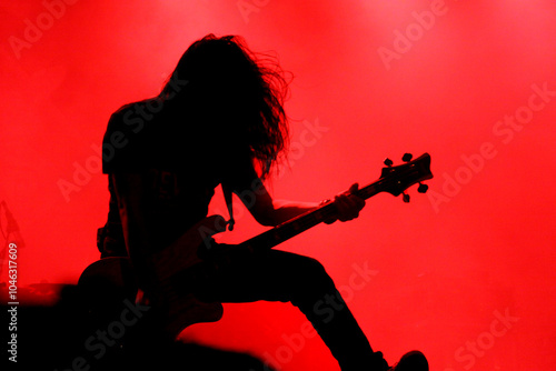 Silhouette of guitar player or guitarist perform on concert stage photo