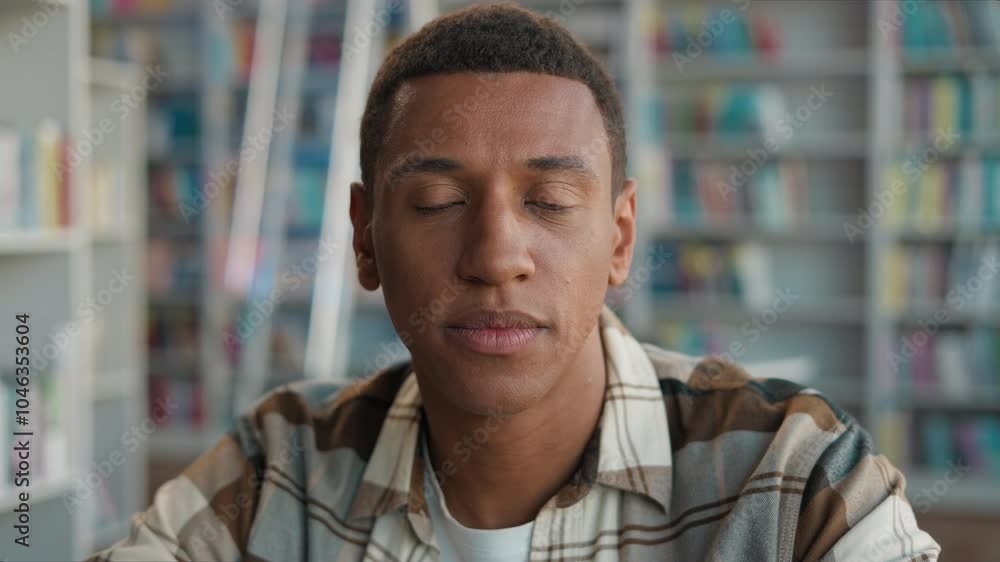 African American man male guy student turn head looking at camera portrait face university high school library college studying learning educational academy pupil learner teenager bookshelves bookshop African American man male guy student turn head looking at camera portrait face university high school library college studying learning educational academy pupil learner teenager bookshelves bookshop