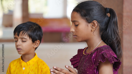 A Hindu family gathered around a sacred fire, performing a Yagya during a festival celebration photo