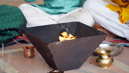 A Hindu family gathered around a sacred fire, performing a Yagya during a festival celebration photo