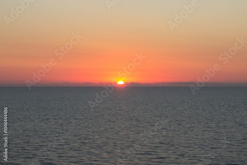 evocative image of sunset over the calm sea on a beautiful day