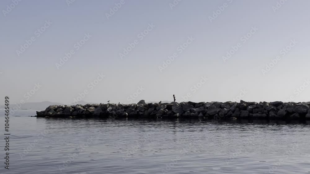 child running and playing on the pier in the sea child running and playing on the pier in the sea