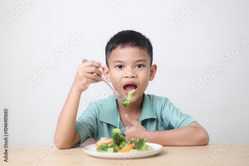 Nutrition healthy eating habits for kids concept. Children do not like to eat vegetables. Little cute boy refuses to eat healthy vegetables.