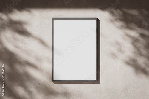 Blank white portrait A0 poster in a metal frame on a plaster wall