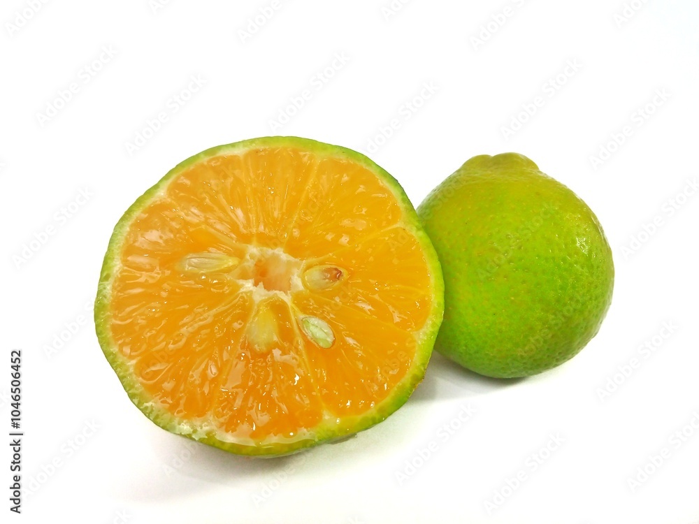 Lemon and slice isolated on white background. orange peel is green Lemon and slice isolated on white background. orange peel is green