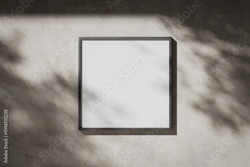 White blank square poster in a metal frame on a plaster wall