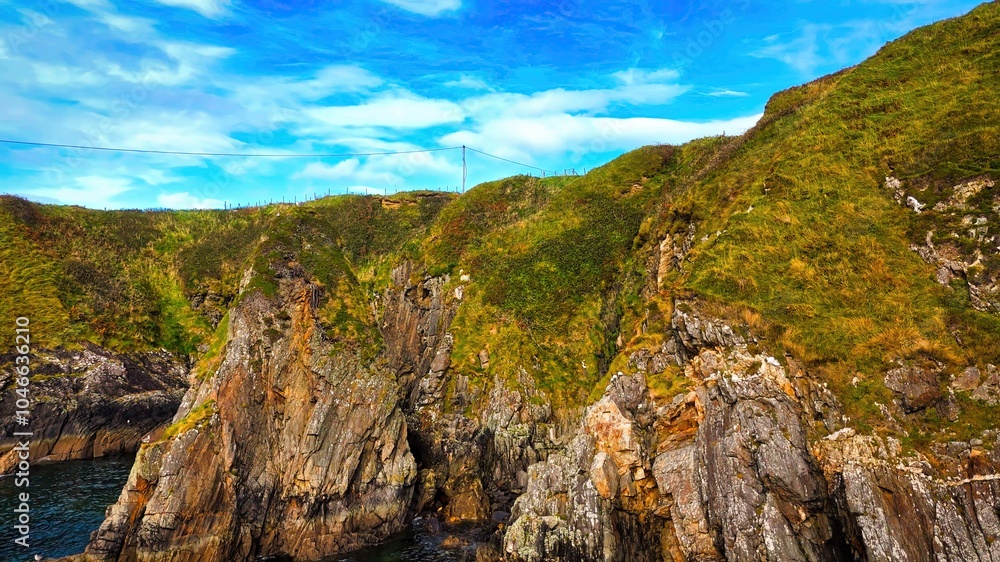 Enjoy the breathtaking view of a stunning coastal landscape with rocky cliffs and serene waters Enjoy the breathtaking view of a stunning coastal landscape with rocky cliffs and serene waters