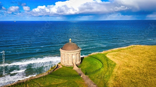 Mussenden Temple at the west coast of Northern Ireland in an enchanting Coastal Landscape featuring a Historic Building beautifully situated by the Sea photo