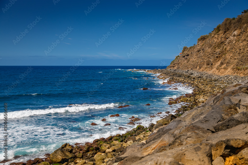 Capturing the essence of Tenerife’s El Socorro beach with rocky cliffs and rolling waves Capturing the essence of Tenerife’s El Socorro beach with rocky cliffs and rolling waves