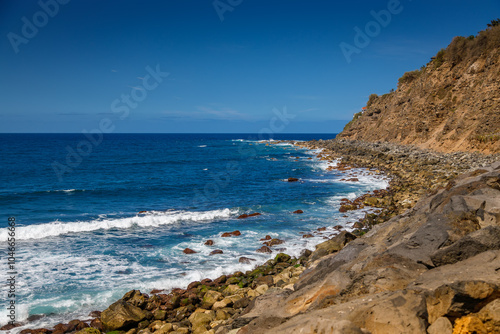 Capturing the essence of Tenerife’s El Socorro beach with rocky cliffs and rolling waves