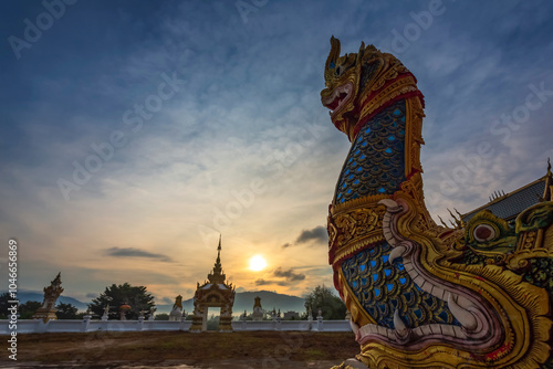 Wat Khao Sawan Thak is a Lanna-style temple at sunrise in Chanthaburi Province. It has beautiful architecture surrounded by nature.