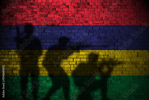 mauritius flag on brick wall and soldiers shadow photo