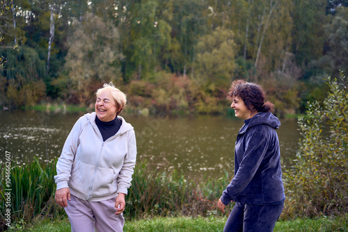 middle-aged woman and her old mother laughing during a morning jog together, for maintaining health by the river in autumn