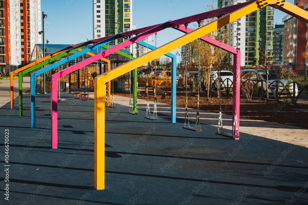 A vibrant and colorful structure situated in a lovely park area, complemented by buildings in the background that enhance the urban landscape and environment surrounding it A vibrant and colorful structure situated in a lovely park area, complemented by buildings in the background that enhance the urban landscape and environment surrounding it