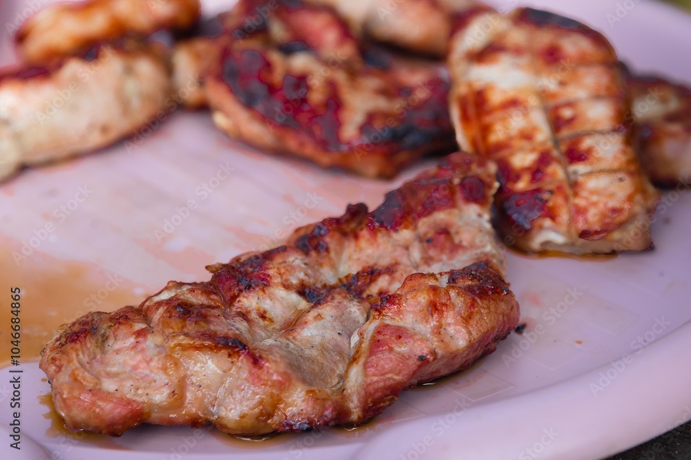 Grilled Meat with a Delicious Crispy Crust on a Plate Grilled Meat with a Delicious Crispy Crust on a Plate