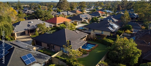 Aerial view of luxurious suburban homes with pools in modern Australia.