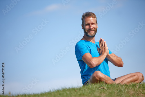 Portrait, prayer hands and man on grass for meditation, mockup space or holistic health for soul. Sit, yoga and zen yogi in park for mindfulness, chakra balance or peace with awareness or fresh air