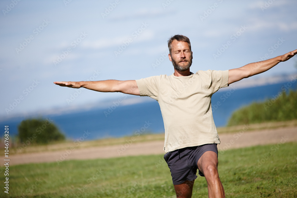 Park, man and stretching in nature with yoga for exercise, balance and mobility on grass. Pilates, mature yogi and warrior pose on lawn for workout, holistic wellness and posture with fitness outdoor Park, man and stretching in nature with yoga for exercise, balance and mobility on grass. Pilates, mature yogi and warrior pose on lawn for workout, holistic wellness and posture with fitness outdoor
